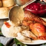 pouring giblet gravy on turkey