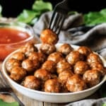 person eating a Hawaiian meatball