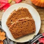two slices of Starbucks pumpkin pepita loaf on a white plate