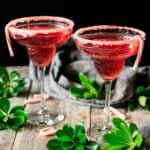 two candy cane mocktails in margarita glasses