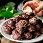 person holding a coconut truffle