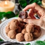 person holding a French chocolate truffle