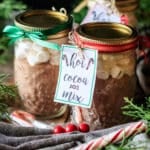 glass jars of hot cocoa mix with gift tags