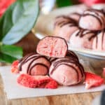 stack of strawberry truffles on parchment paper
