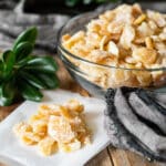 candied ginger on parchment paper and in a glass bowl