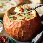 holding a spoonful of baked potato soup