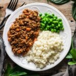 mince and tatties with green peas and black forks