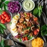 bowl of Chick-fil-A Cobb salad with two black forks.