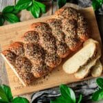 baked loaf of everything bagel bread on a cutting board.