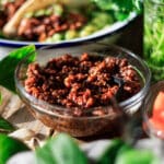 glass bowl of quinoa taco meat with a fork.