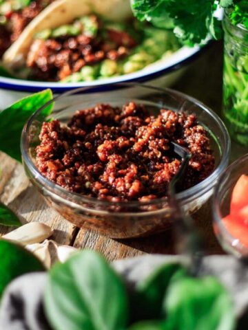bowl of quinoa taco meat with taco toppings.