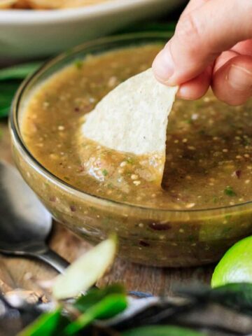 dipping a tortilla chip into Chipotle green chili salsa.