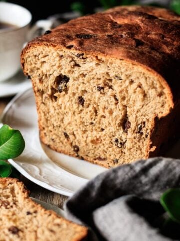 sliced Lincolnshire plum bread on a white platter.