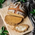 sliced whole wheat molasses bread on a cutting board.