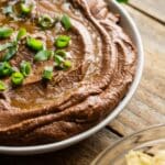 closeup of black bean hummus drizzled with olive oil.