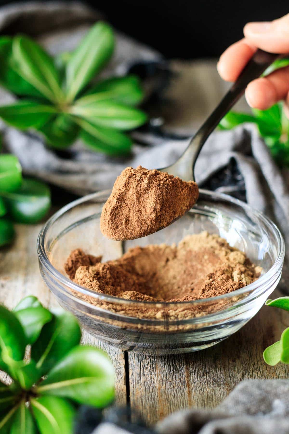 holding a spoonful of pumpkin pie spice.