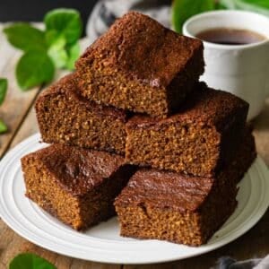 stack of parkin on a plate with a cup of tea.