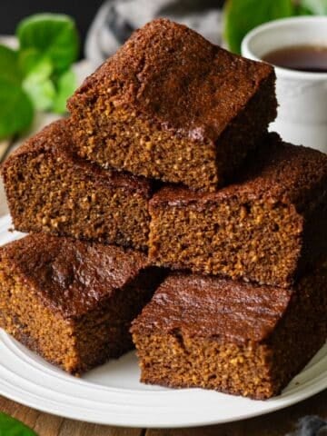 stack of parkin on a plate with a cup of tea.