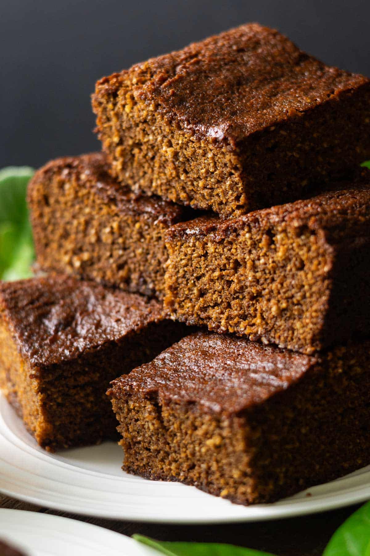 large slices of parkin stacked on a white plate.