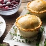 two turkey cranberry pies on a rectangular plate.