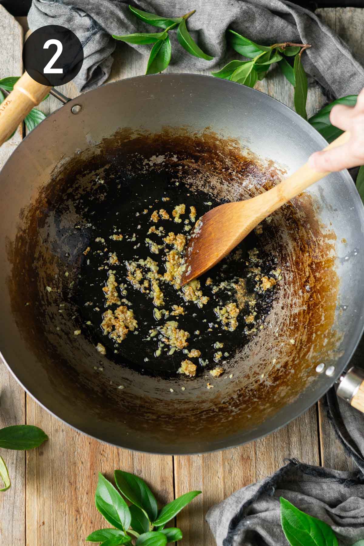 cooking the garlic and ginger in a wok.