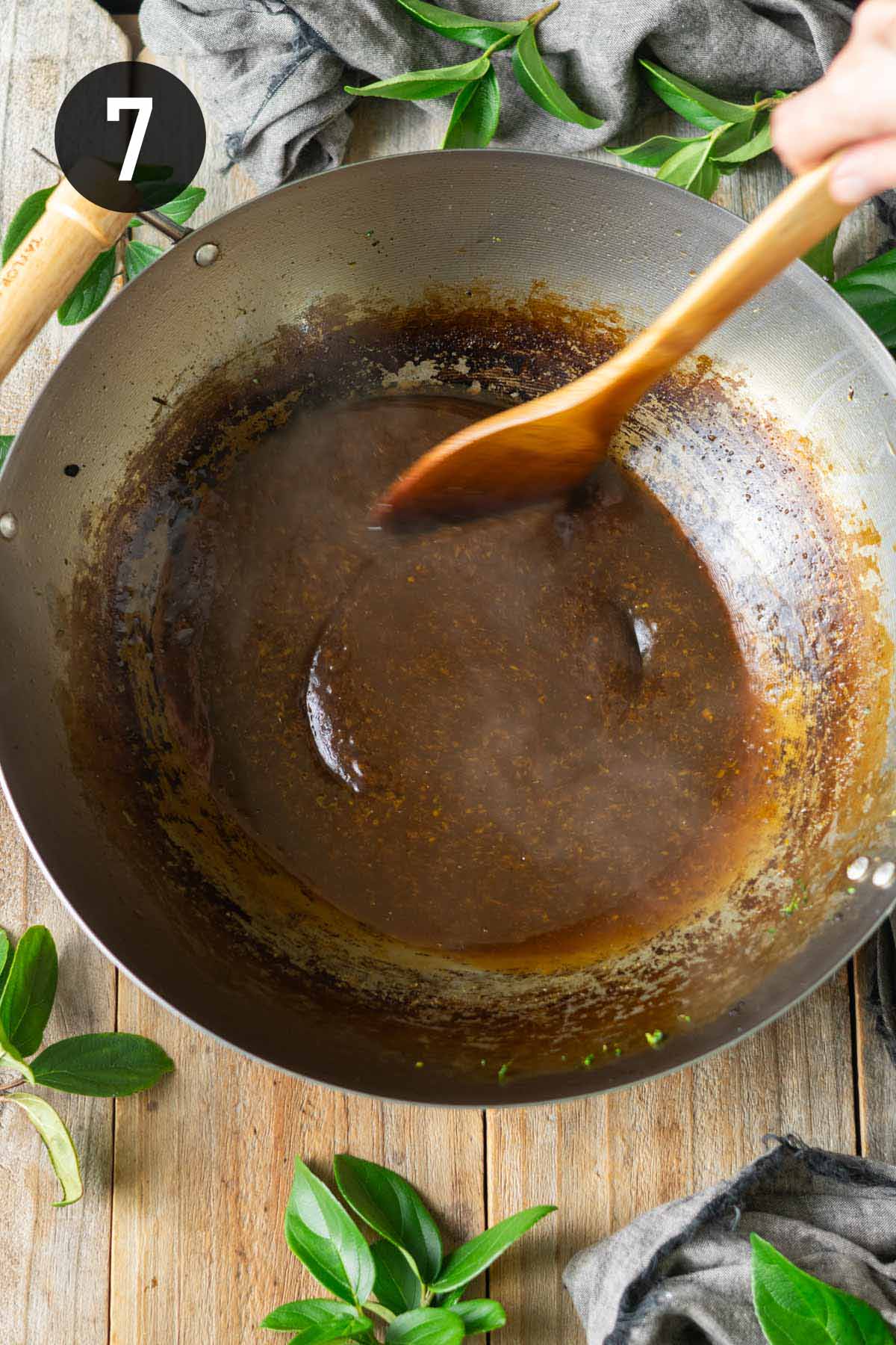 thickening the sauce in the wok.