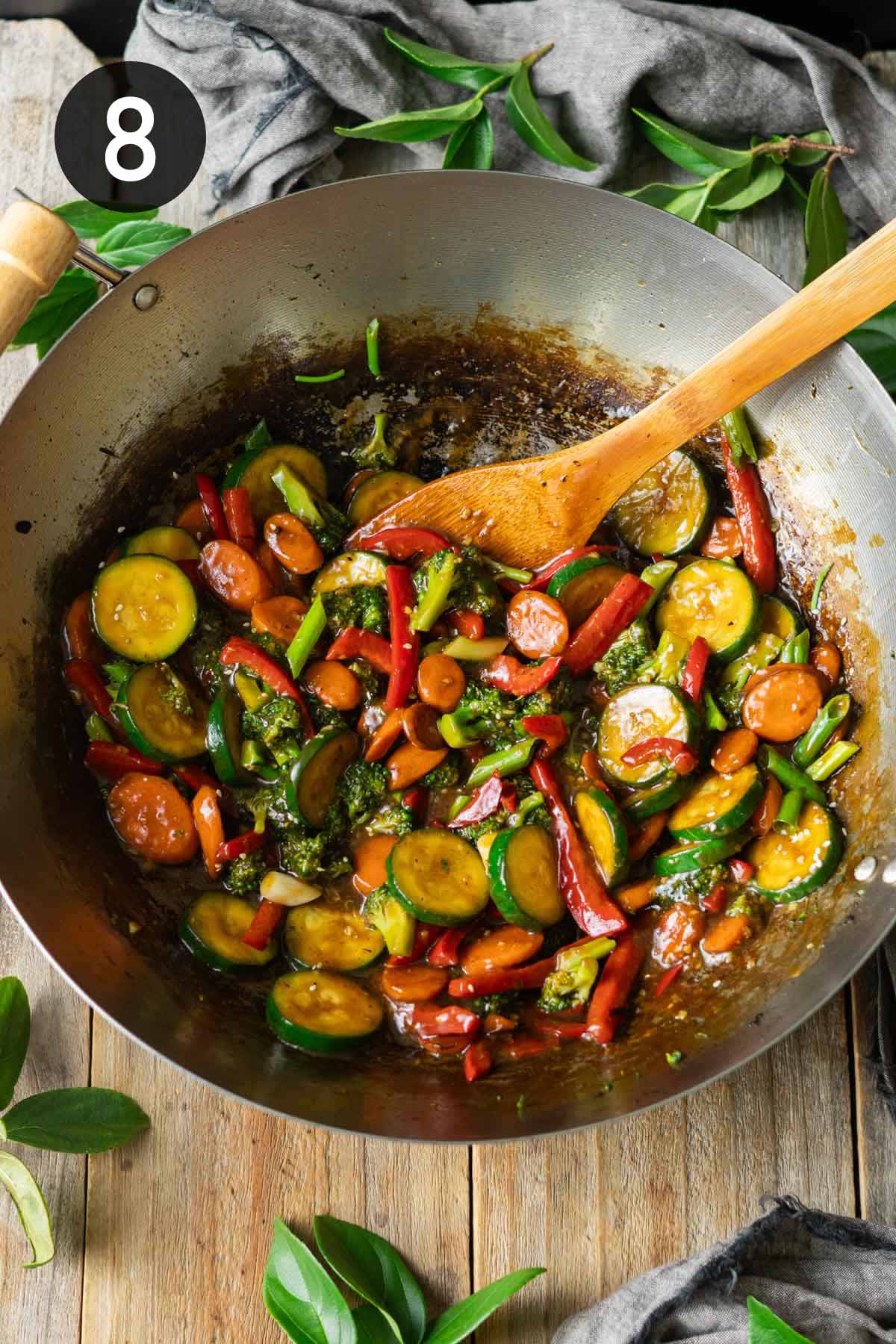 finished stir fry in a wok with a spoon.