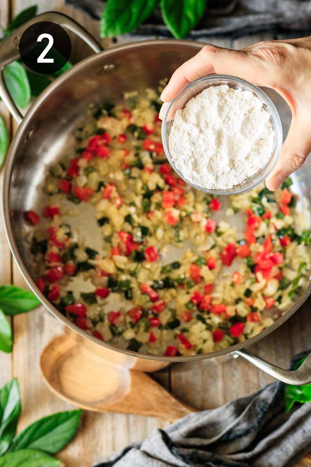 adding flour to sautéed veggies.