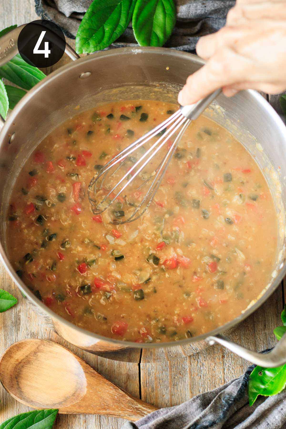 whisking the flour and vegetables in a pot.