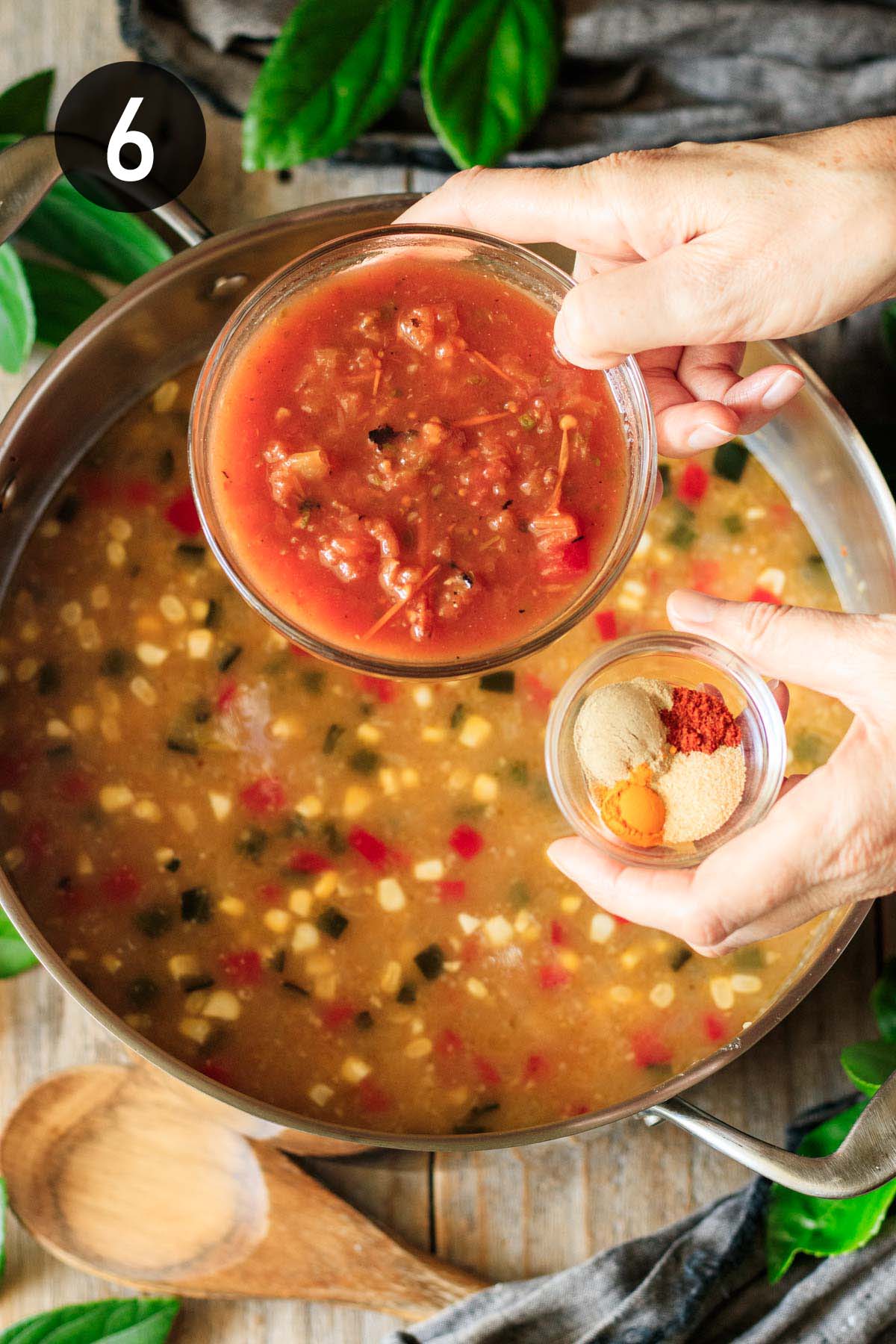 adding the salsa and spices to the chowder.