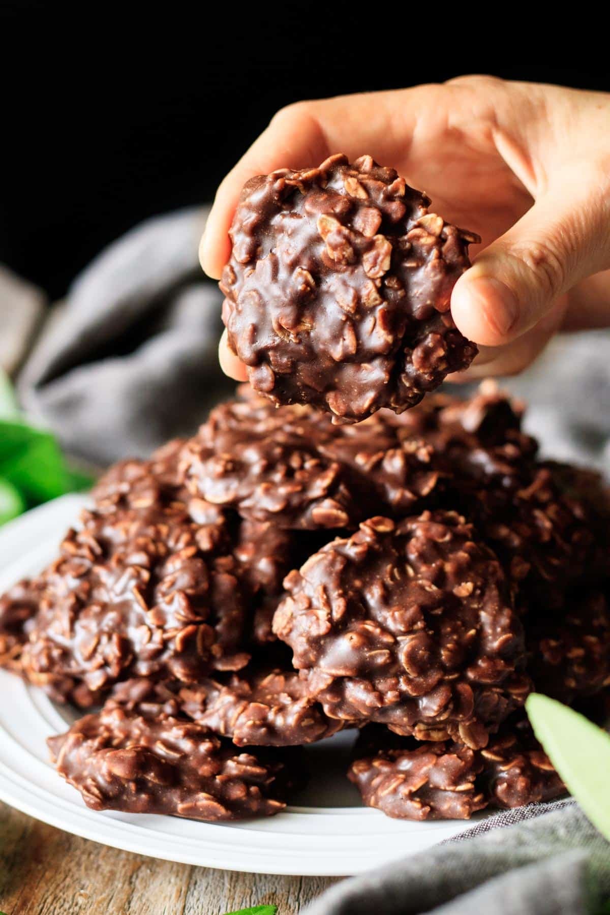 person holding a no bake chocolate peanut butter cookie.