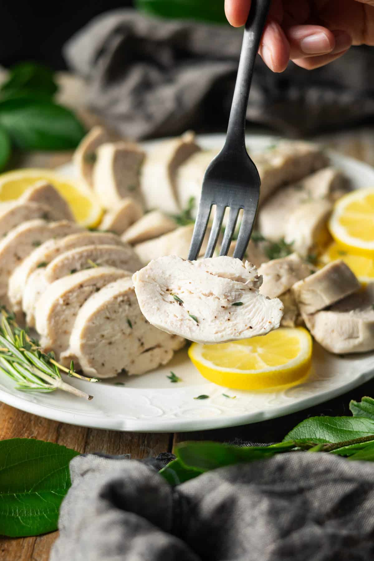 holding a forkful of poached chicken.