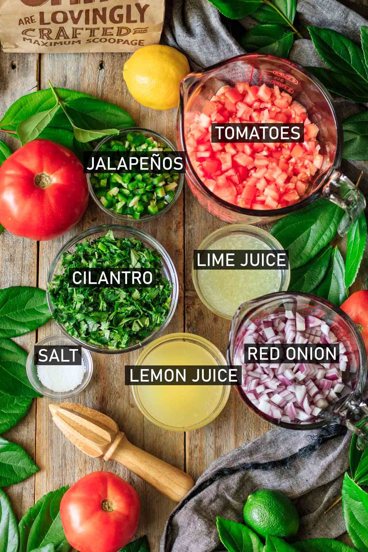 glass bowls of ingredients for Chipotle fresh tomato salsa.