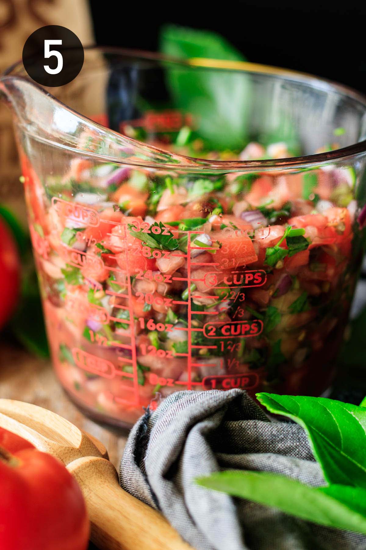 glass measuring cup of salsa.