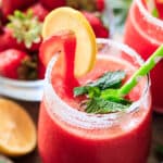 a glass of frozen strawberry lemonade with a straw.