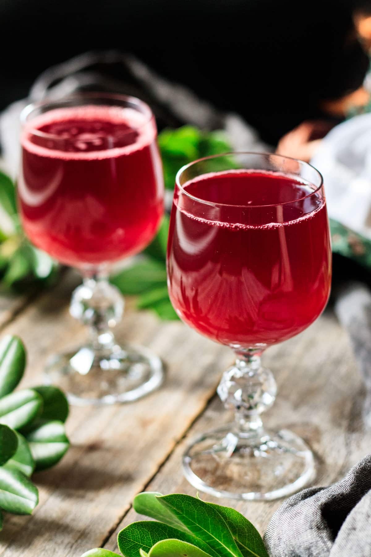 two stemmed glasses of raspberry cordial.