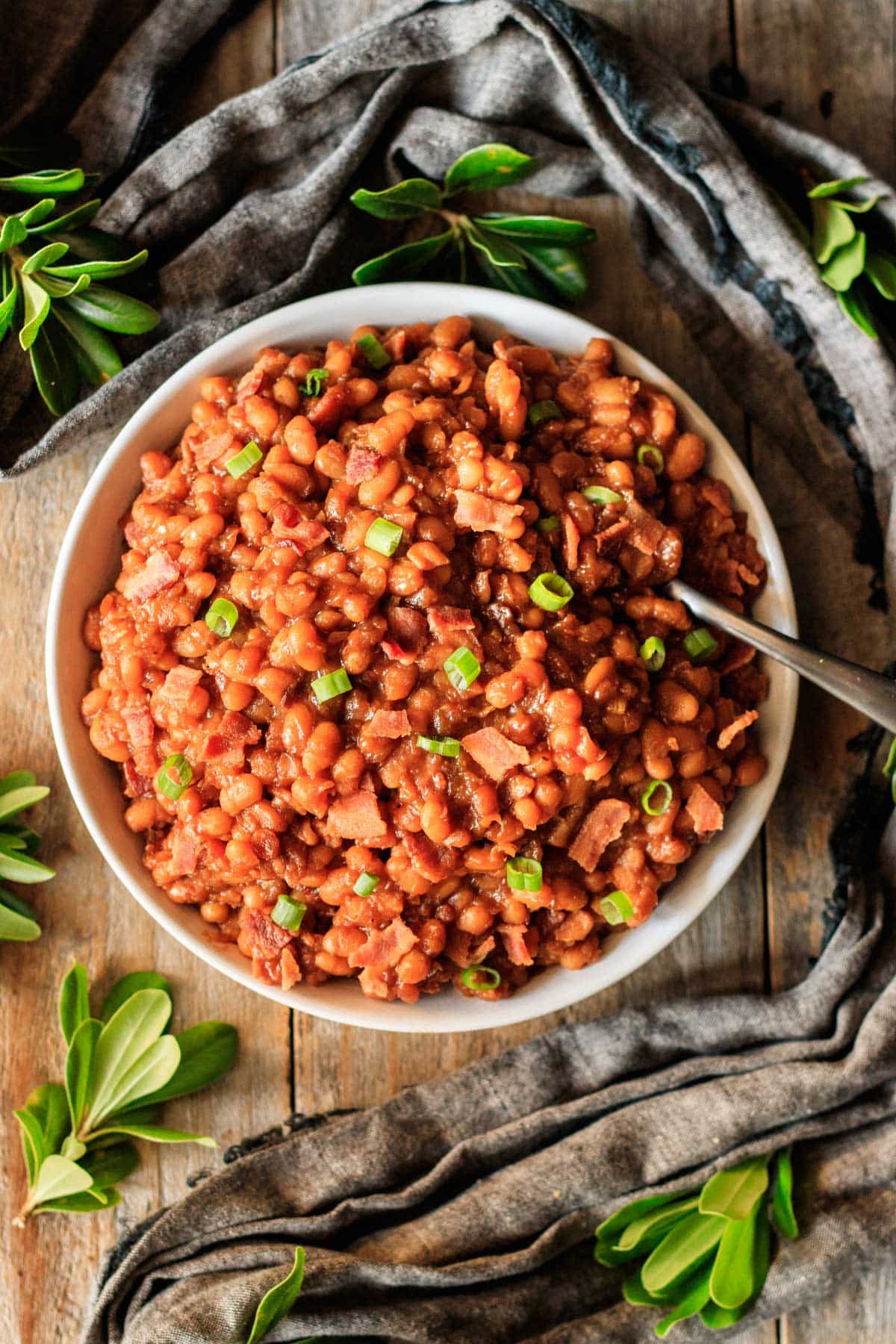 bowl of Southern baked beans with a spoon.