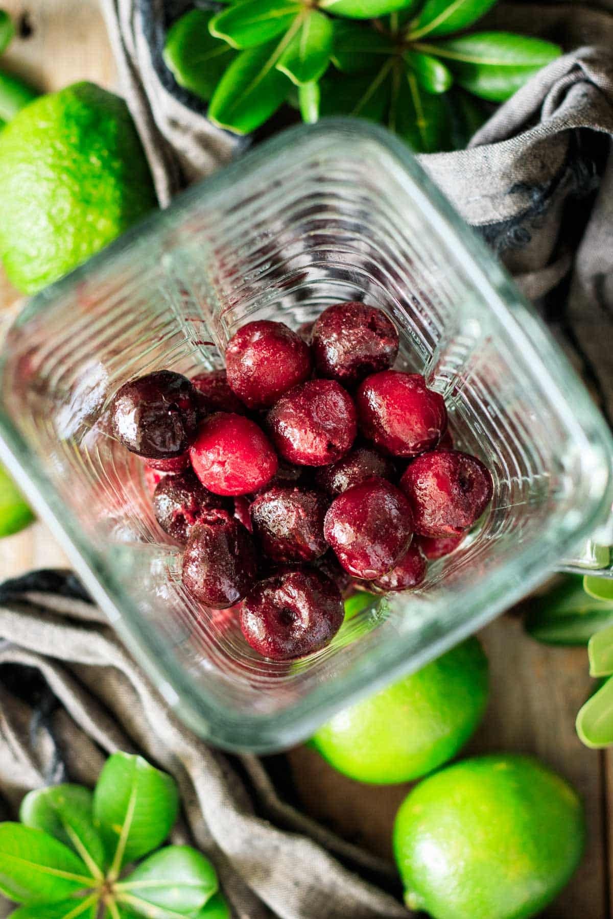 frozen cherries and limeade in a glass blender pitcher.