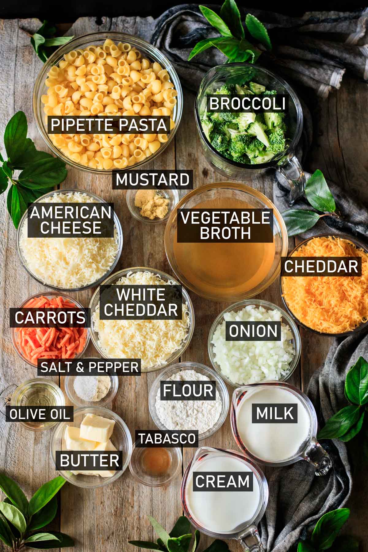 glass bowls of ingredients for Panera broccoli mac and cheese.