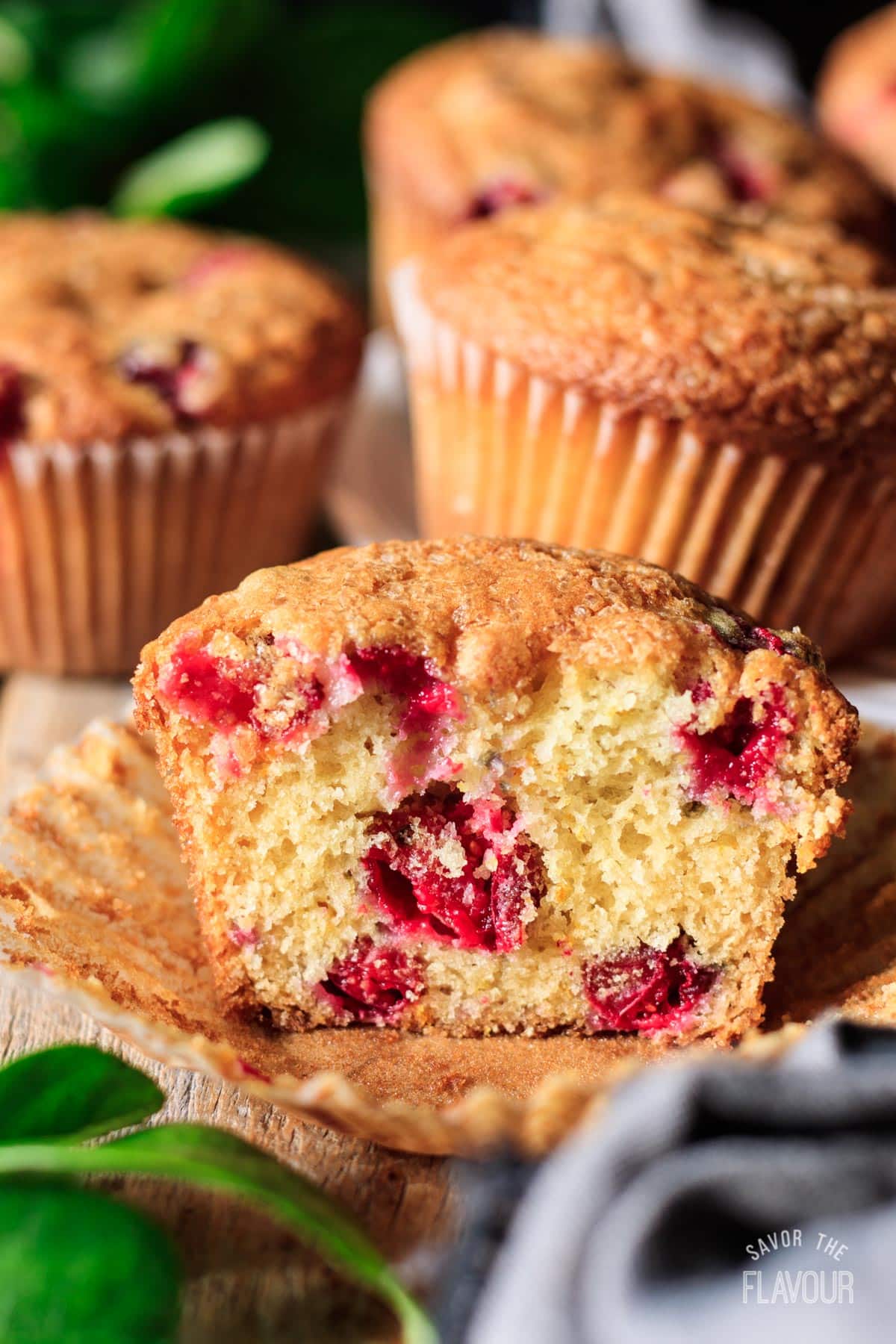 half of a cranberry orange muffin on a cupcake wrapper.
